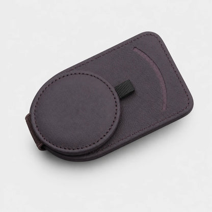Josh & Tate - SunglassClip™ Car Visor Organizer - A dark purple magnetic phone case with a circular magnetic ring and a small black strap, shown on a light gray background.