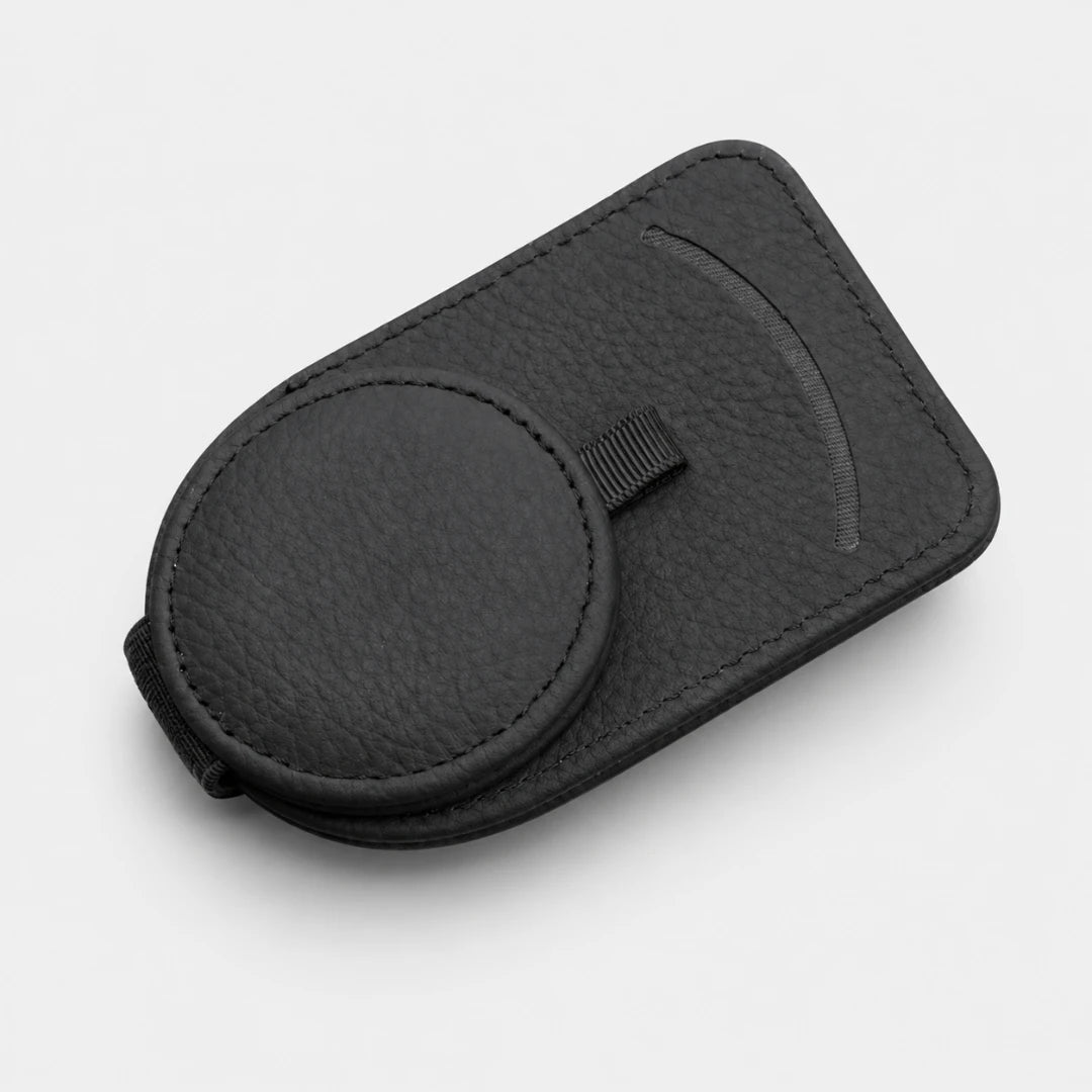Josh & Tate - SunglassClip™ Car Visor Organizer - A black textured leather magnetic phone case with a circular magnetic ring and a small black strap, shown on a light gray background.
