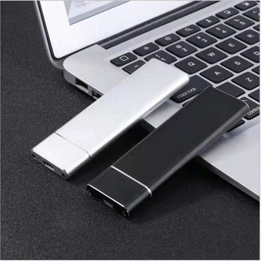 Two USB drives, one silver and one black, in front of a laptop.