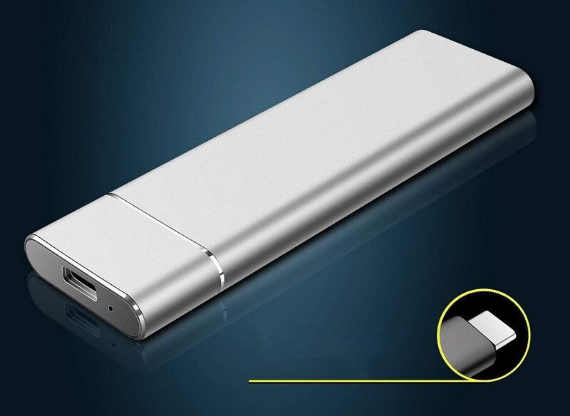 Silver USB drive on a reflective dark blue surface with a close-up inset showing the connector.