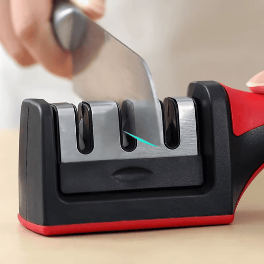 A knife being sharpened using a compact black and red Tairo knife sharpener.