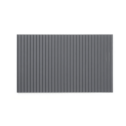 A gray non-slip mat with a ribbed texture designed to fit on a cutting board to provide stability during use.