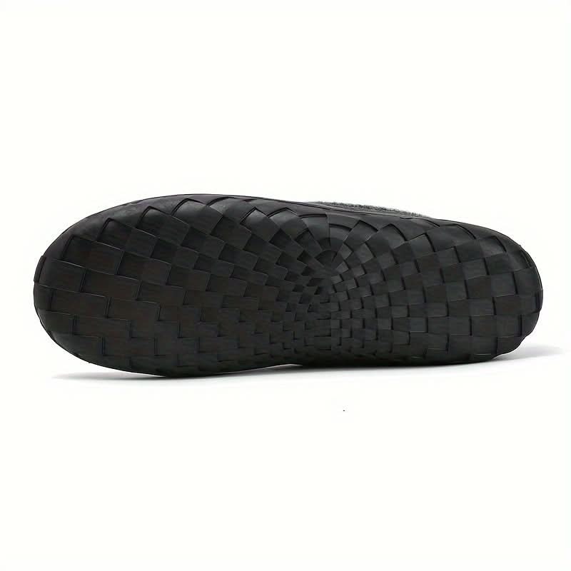 Black woven sandal on a white background