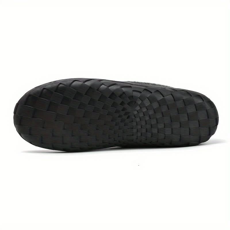 Black woven sandal on a white background