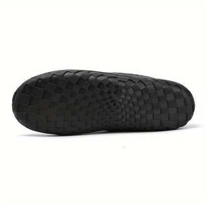 Black woven sandal on a white background