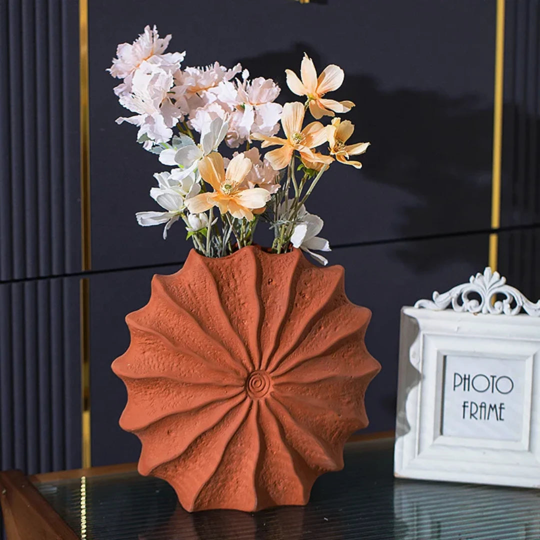 Josh & Tate - Terracotta Flower Vase - Decorative orange vase with flowers on a reflective surface