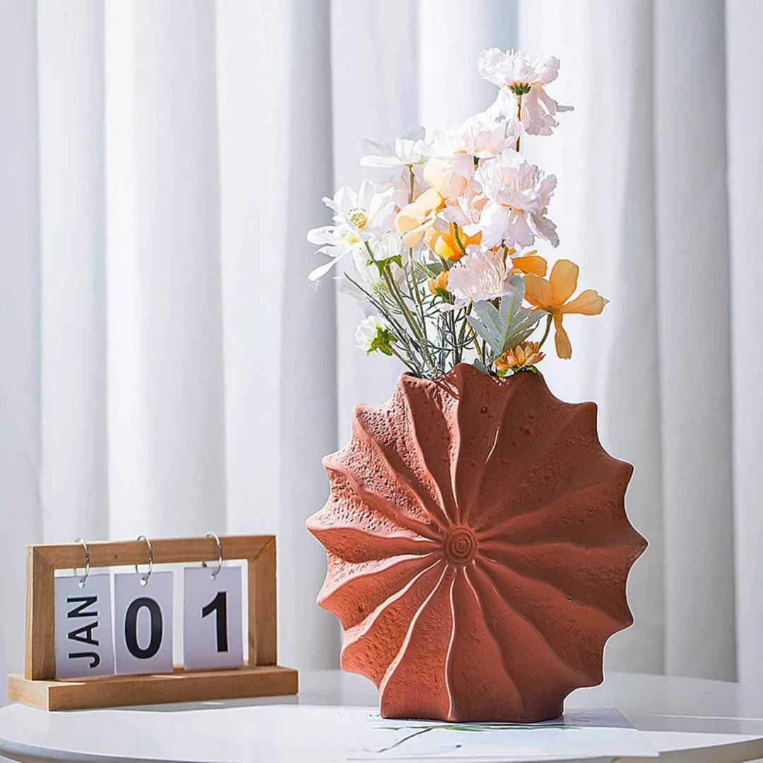 Josh & Tate - Terracotta Flower Vase - Decorative terracotta vase with flowers on a white surface against a white curtain background