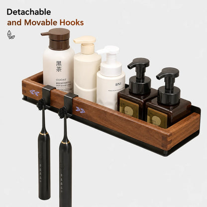 Josh & Tate - TimberLedge™ Wall Organizer - A wooden bathroom organizer tray with black metal hooks holding two electric toothbrushes and several toiletry bottles, shown on a light gray background with text reading 'Detachable and Movable Hooks.' The main sellable item appears to be the wall-mounted organizer set rather than the bottles or toothbrushes alone.