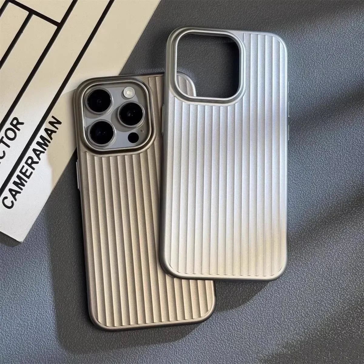 Two phone cases with ribbed texture on a gray surface
