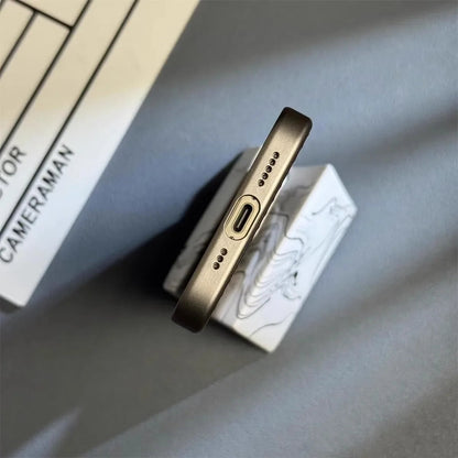 Gold phone case on a white box with 'Cammeraman' branding on a gray surface