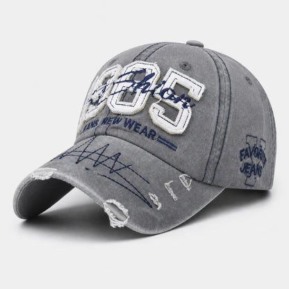 Josh & Tate - TrailFade™ '85 Cap - A gray washed baseball cap with distressed details, featuring white and navy embroidered patches on the front and side.
