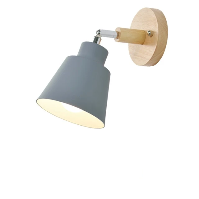 Wall-mounted lamp with gray shade and wooden base on a white background