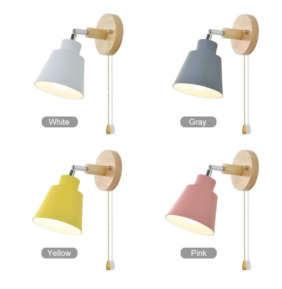 Wall lights in gray, yellow, and pink with wooden brackets on a white background.