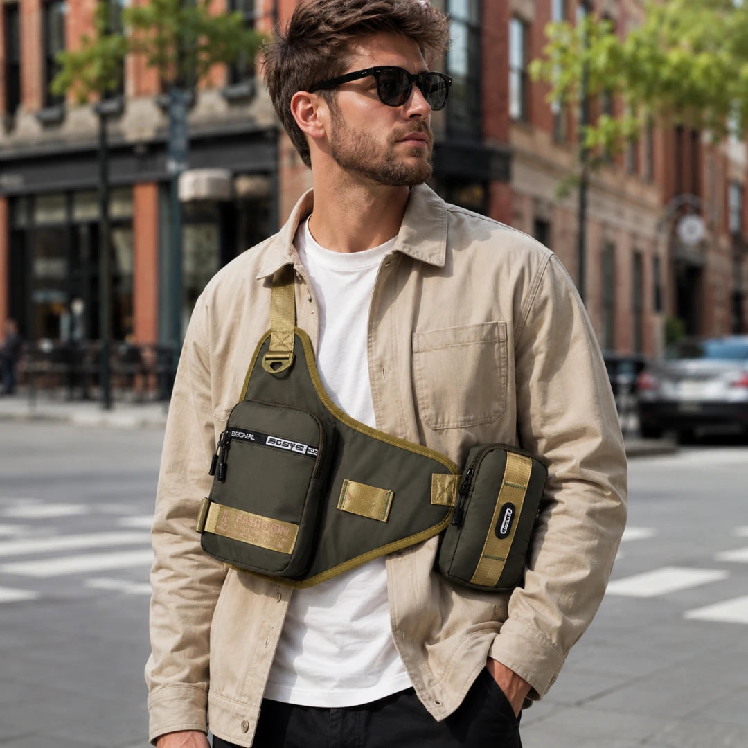 Josh & Tate - UrbanCore™ Crossbody Bag - A man wearing a beige overshirt and sunglasses models an olive green tactical sling bag with a matching side pouch on a city street.