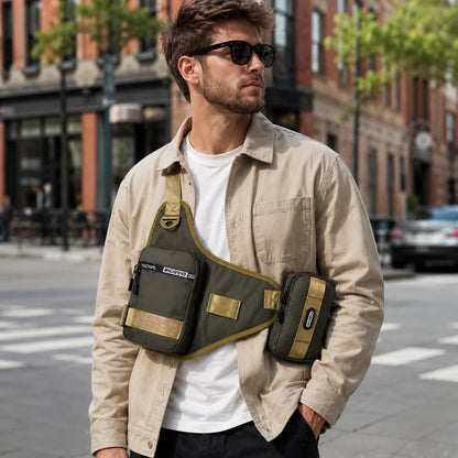 Josh & Tate - UrbanCore™ Crossbody Bag - A man wearing a beige overshirt and sunglasses models an olive green tactical sling bag with a matching side pouch on a city street.