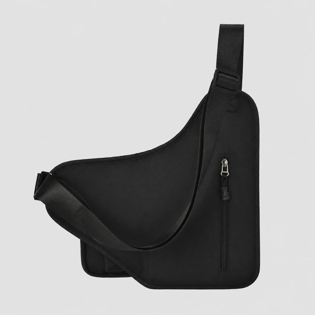 Josh & Tate - UrbanCore™ Crossbody Bag - A black asymmetrical sling bag with an adjustable shoulder strap and a vertical zippered pocket, shown against a light gray background.