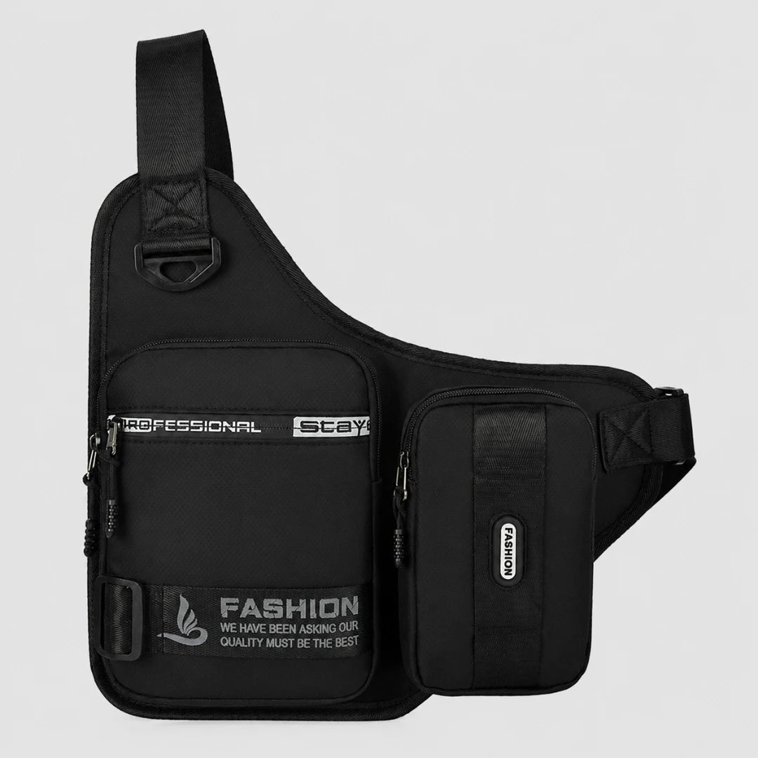 Josh & Tate - UrbanCore™ Crossbody Bag - A black sling shoulder bag with multiple zippered pockets and white printed text, shown against a light gray background.
