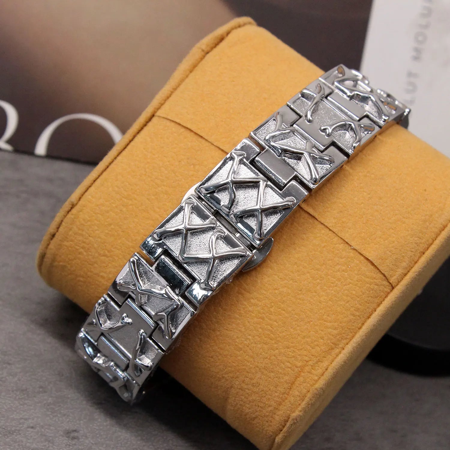 Silver bracelet on a yellow cushion with a blurred background