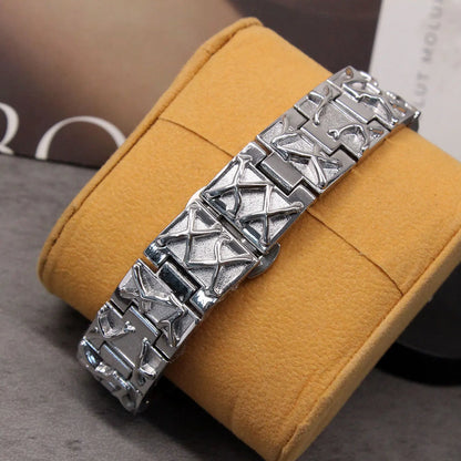 Silver bracelet on a yellow cushion with a blurred background