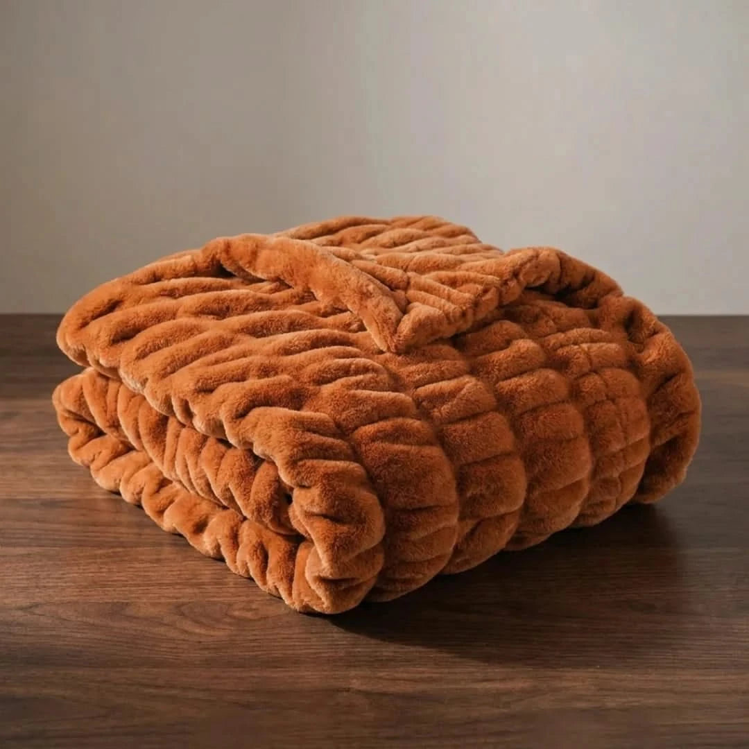 Josh & Tate - VelvetRib™ Faux Fur Throw Blanket - Brown textured blanket on a wooden surface with a neutral background
