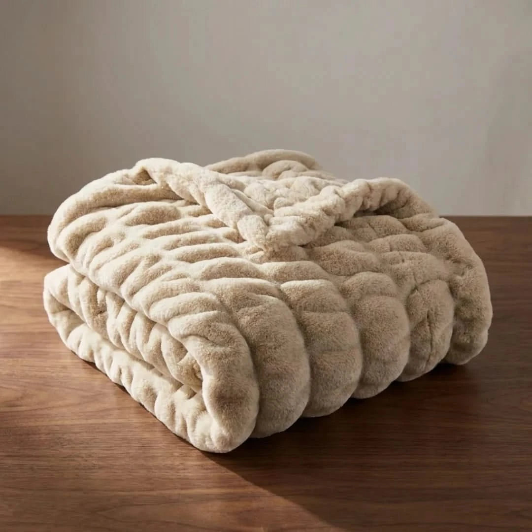 Josh & Tate - VelvetRib™ Faux Fur Throw Blanket - Beige textured blanket on a wooden surface with a neutral background
