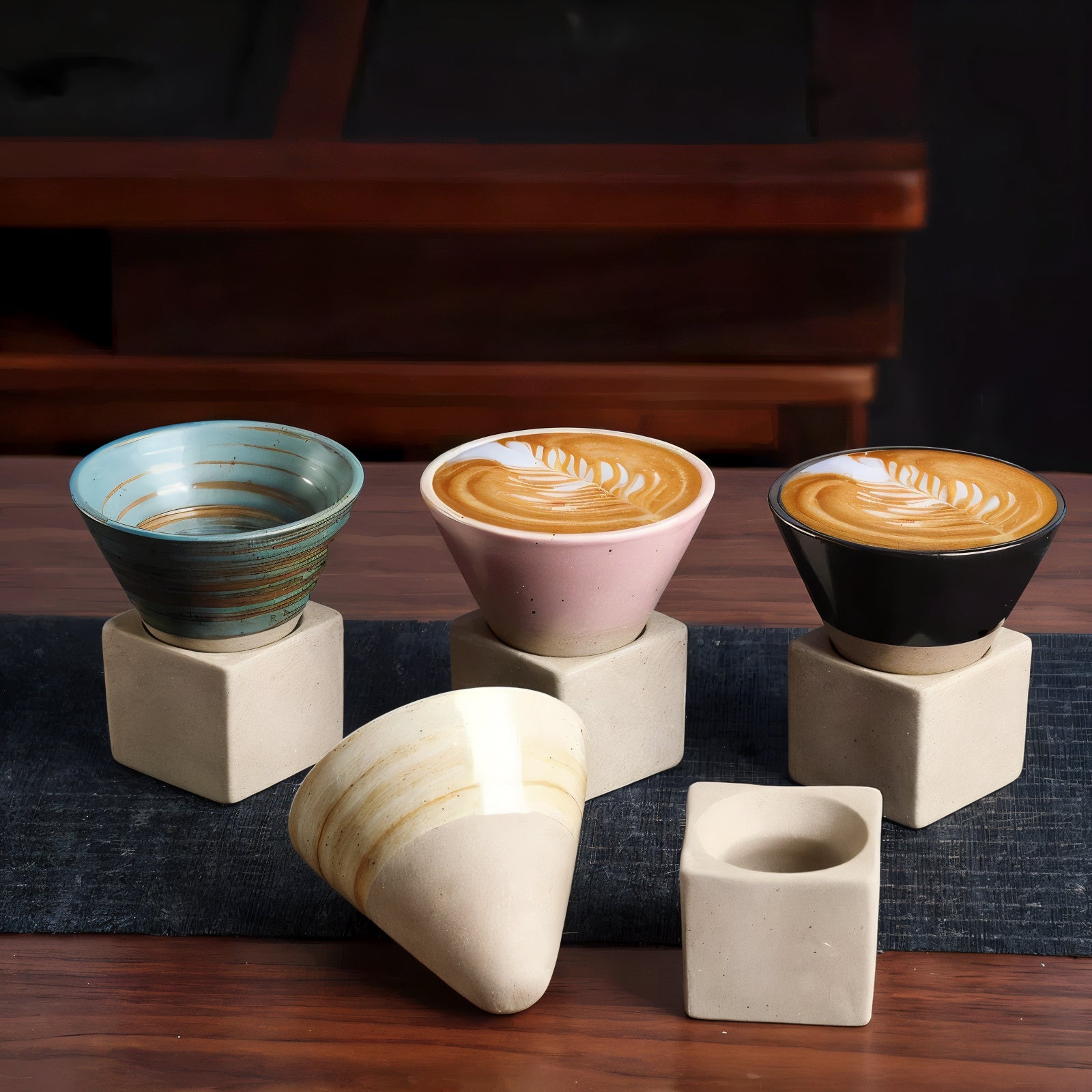 Set of ceramic cups with different designs on a wooden surface