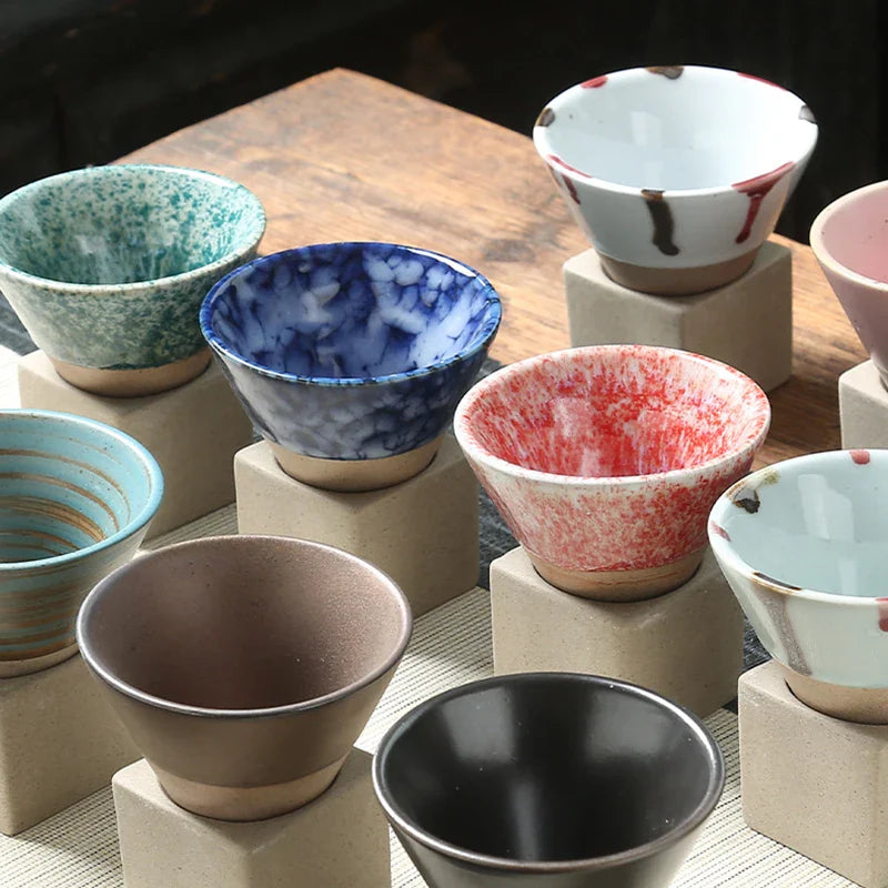Collection of ceramic bowls with various colors and patterns on a wooden surface.