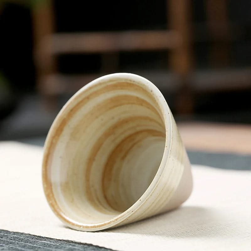 Wooden cup on a light surface with a blurred background