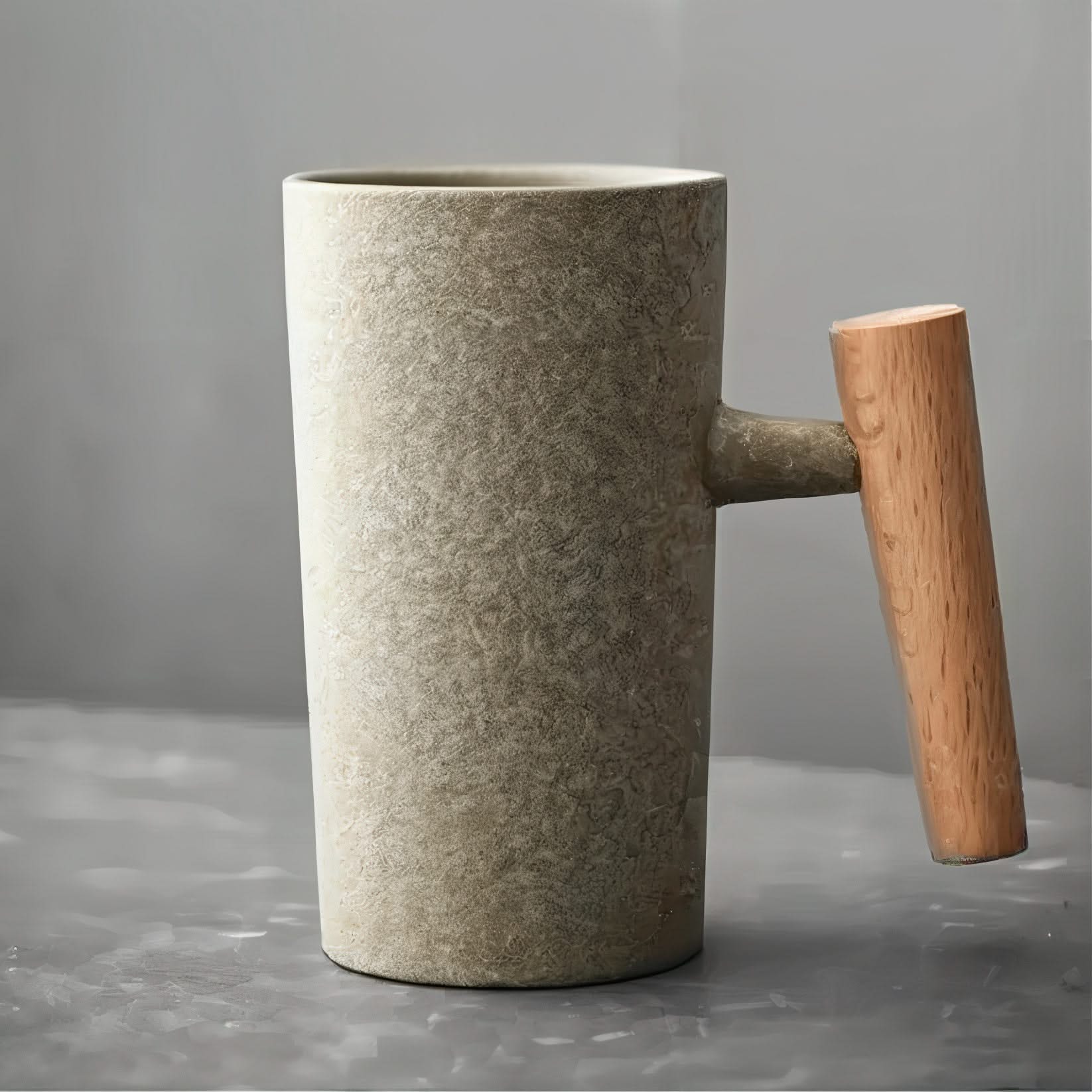 Ceramic mug with wooden handle on a gray background