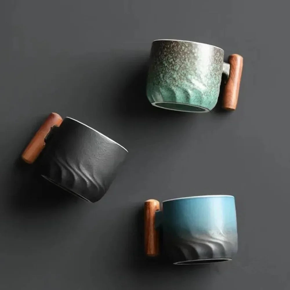Three ceramic mugs with wooden handles on a dark background