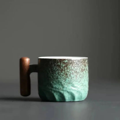 Teal ceramic mug with wooden handle on a dark background