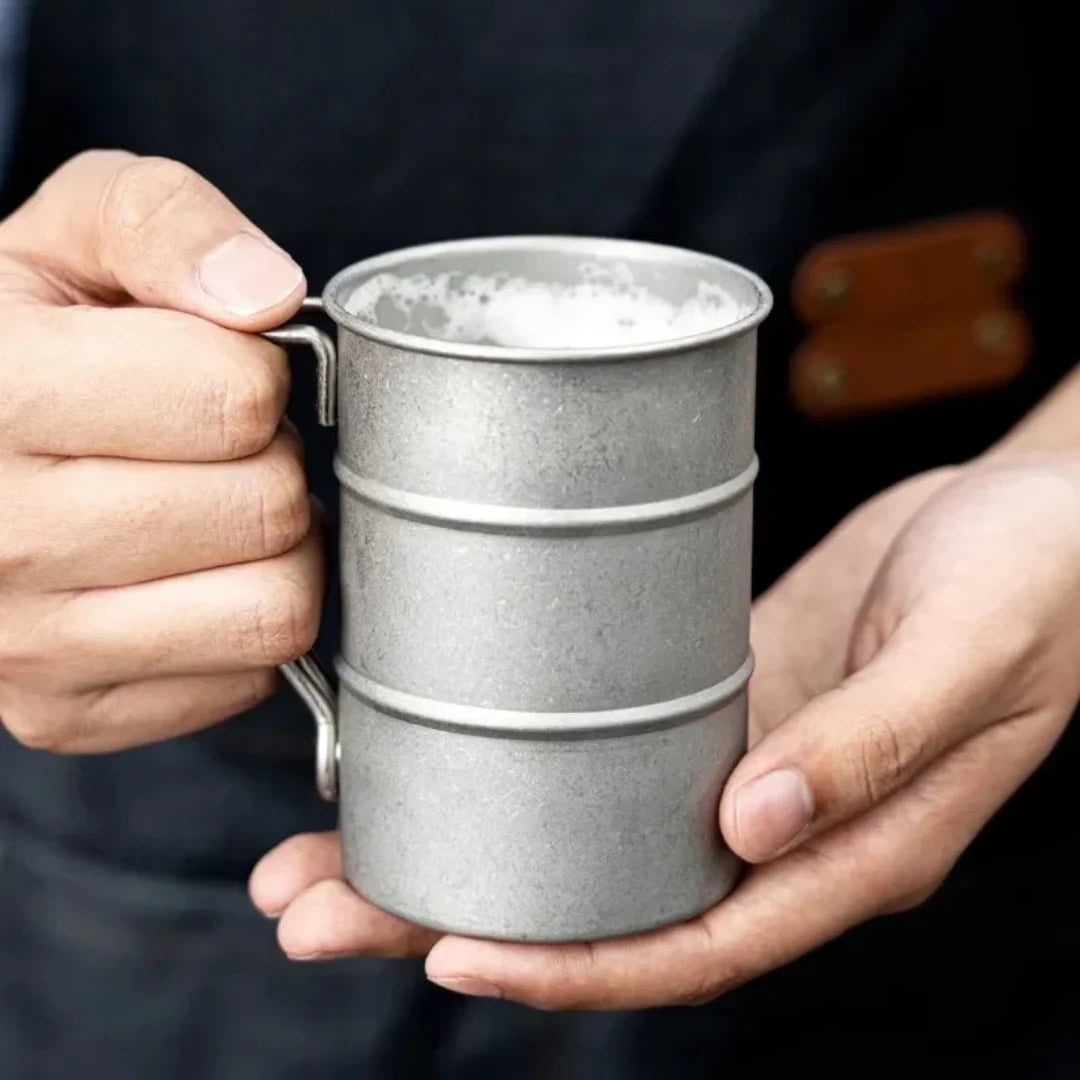 Josh & Tate - Vintage Steel Mug (13oz / 380mL) - Person holding a textured metal mug with a dark background