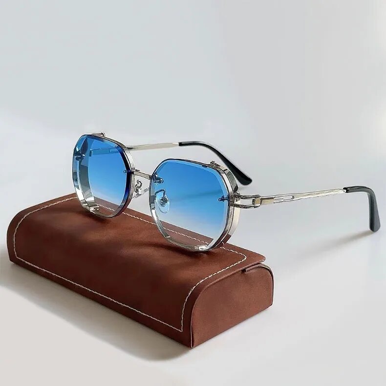 Sunglasses with blue gradient lenses on a brown leather case against a light gray background