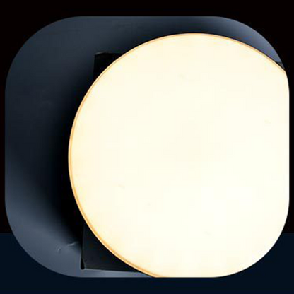 Round light fixture with a dark gray border on a black background