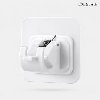Josh & Tate - WallGrip™ Adhesive Rod Clip - White wall hook with coiled spring on a light gray background, featuring the brand 'Josh & Tate'.