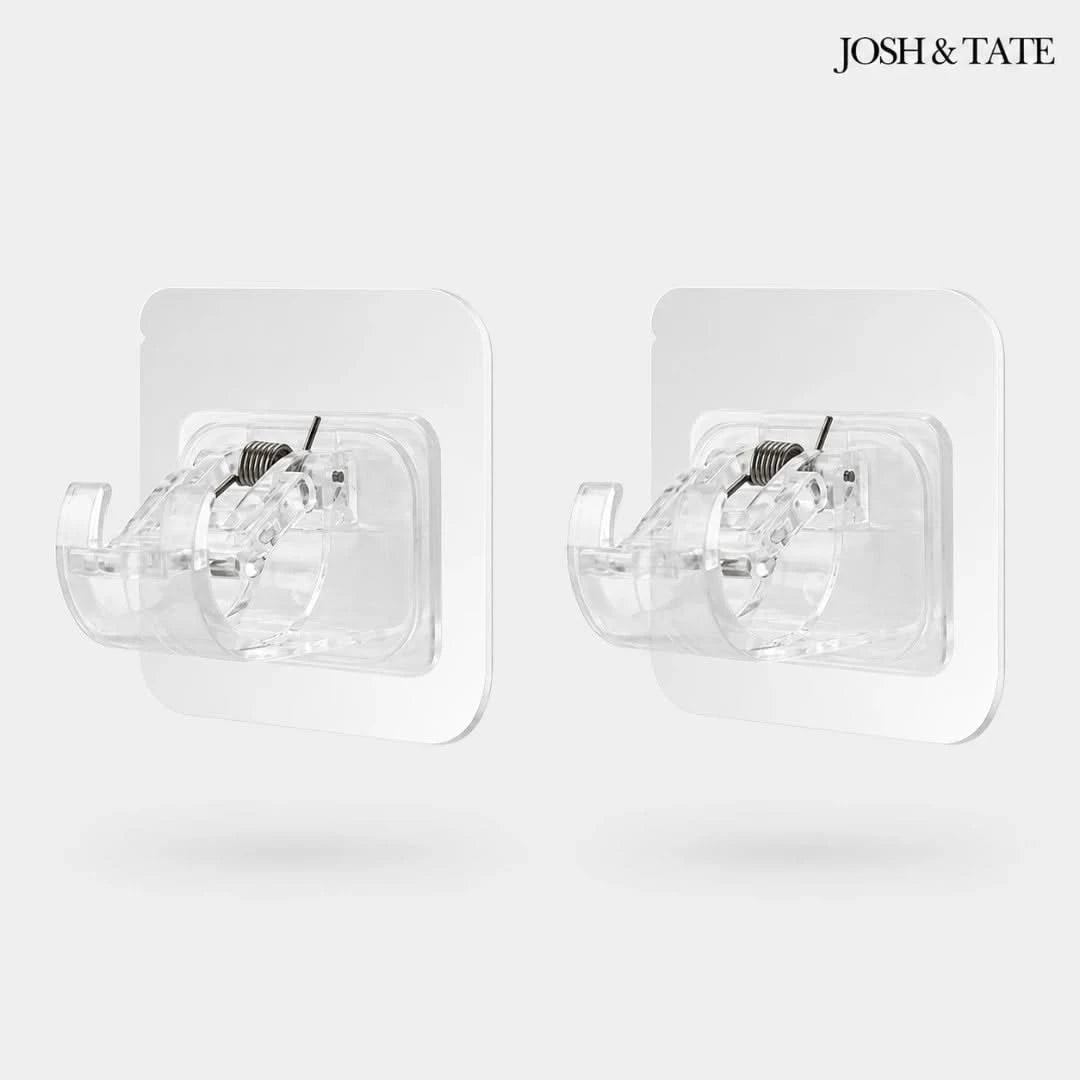 Josh & Tate - WallGrip™ Adhesive Rod Clip - Two clear wall-mounted fans with black blades on a white background, branded 'Josh & Tate'.