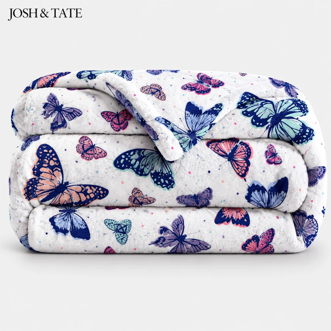 Josh & Tate - WingWrap™ Butterfly Throw Blanket - Folded blanket with butterfly pattern on a white background, featuring the brand 'Josh & Tate'.