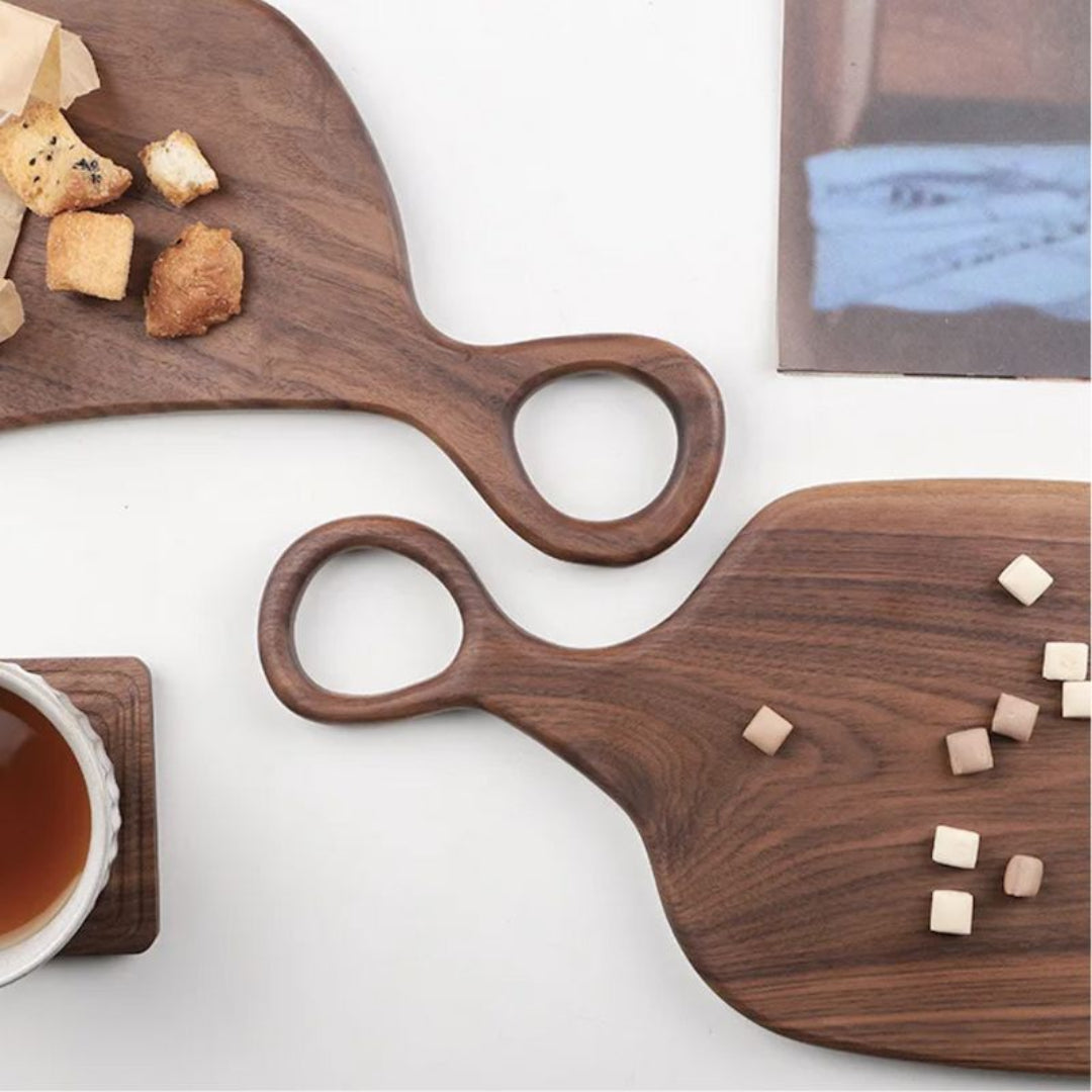 Two wooden serving boards with food on a white surface