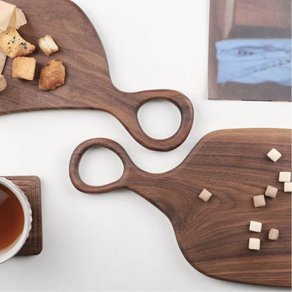 Two wooden serving boards with food on a white surface
