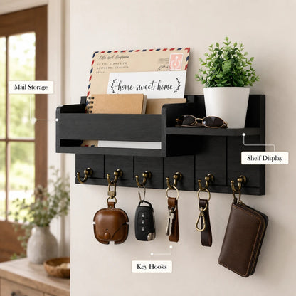 Josh & Tate - WoodenRack™ Wall Organizer - A black wall-mounted organizer with a mail storage slot, shelf display, and key hooks, shown mounted on a beige wall in a home setting with various accessories hanging from the keys.