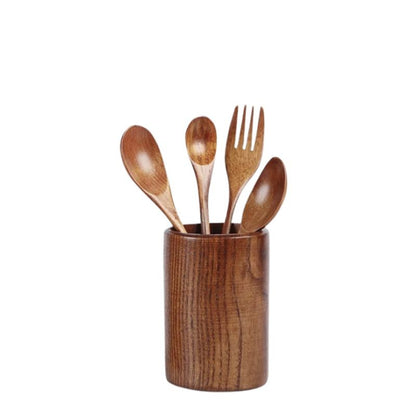 Wooden utensils including a spoon, knife, and fork in a wooden holder on a white background