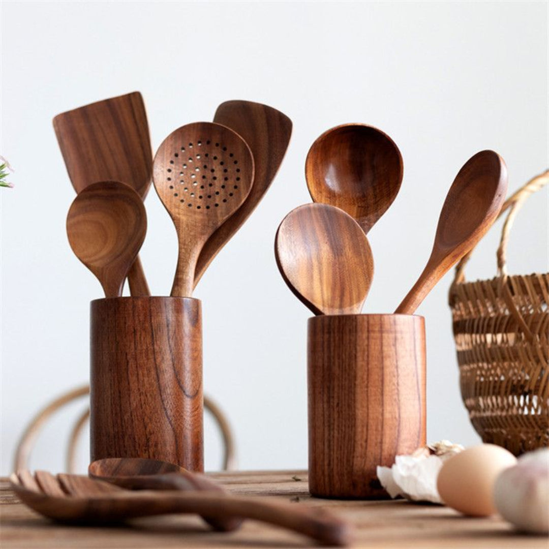 Set of wooden spoons in wooden holders on a wooden surface with a light background