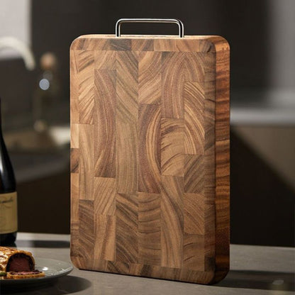 Wooden cutting board with a handle on a kitchen counter