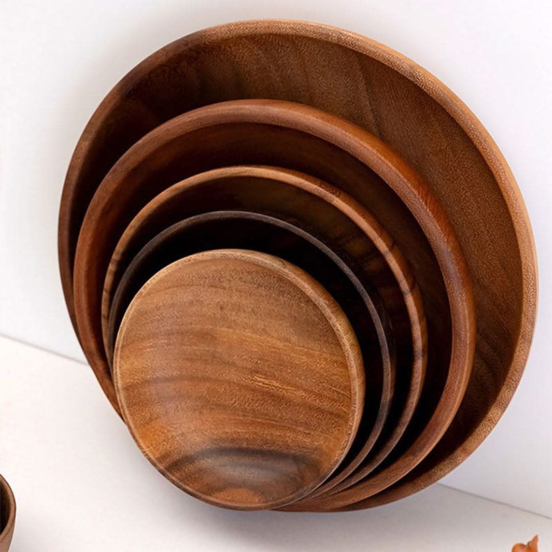 Stack of wooden bowls on a white background
