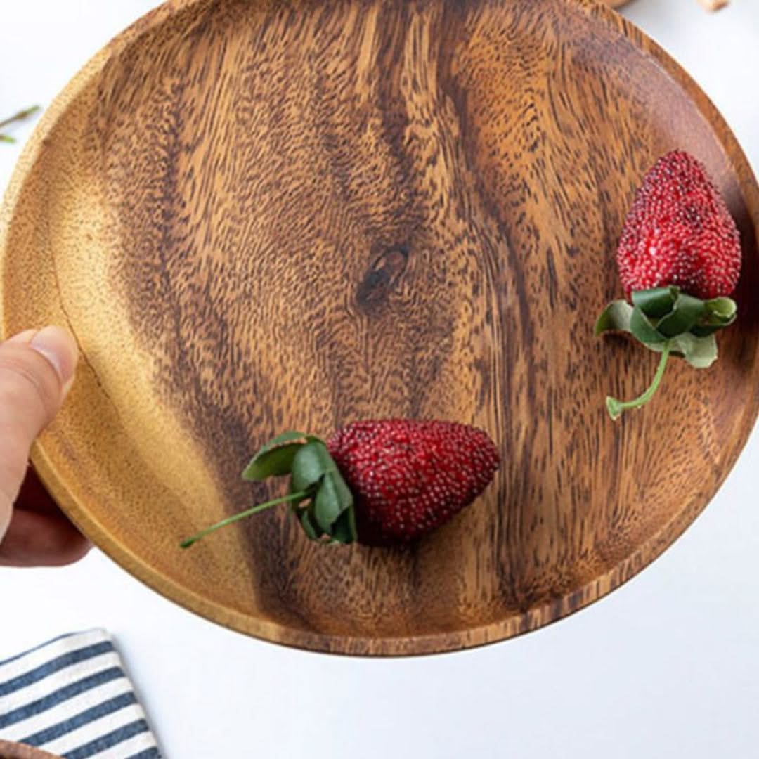 Wooden plate with two strawberries on a white background