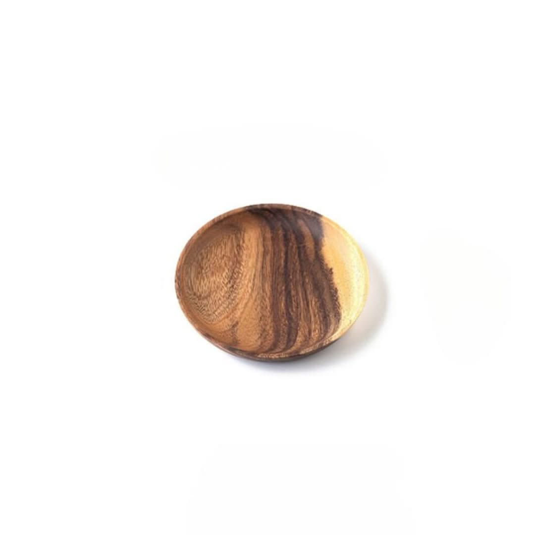 Wooden ball with a striped pattern on a white background
