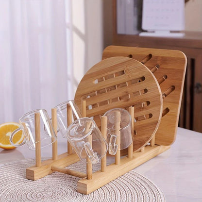 Wooden dish drying rack with clear glass cups on a kitchen counter.