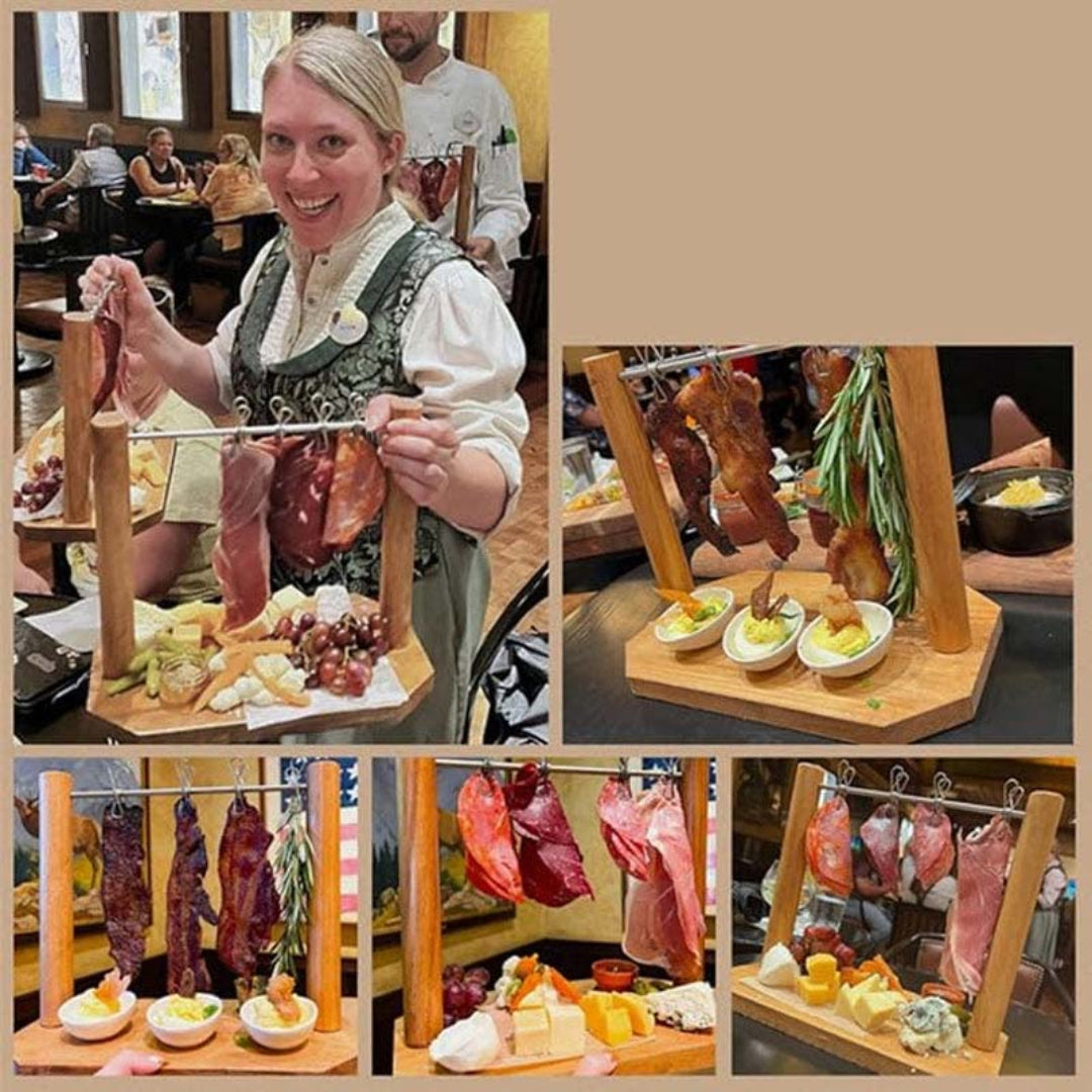 Woman holding a wooden board with cured meats and cheeses in a restaurant setting.