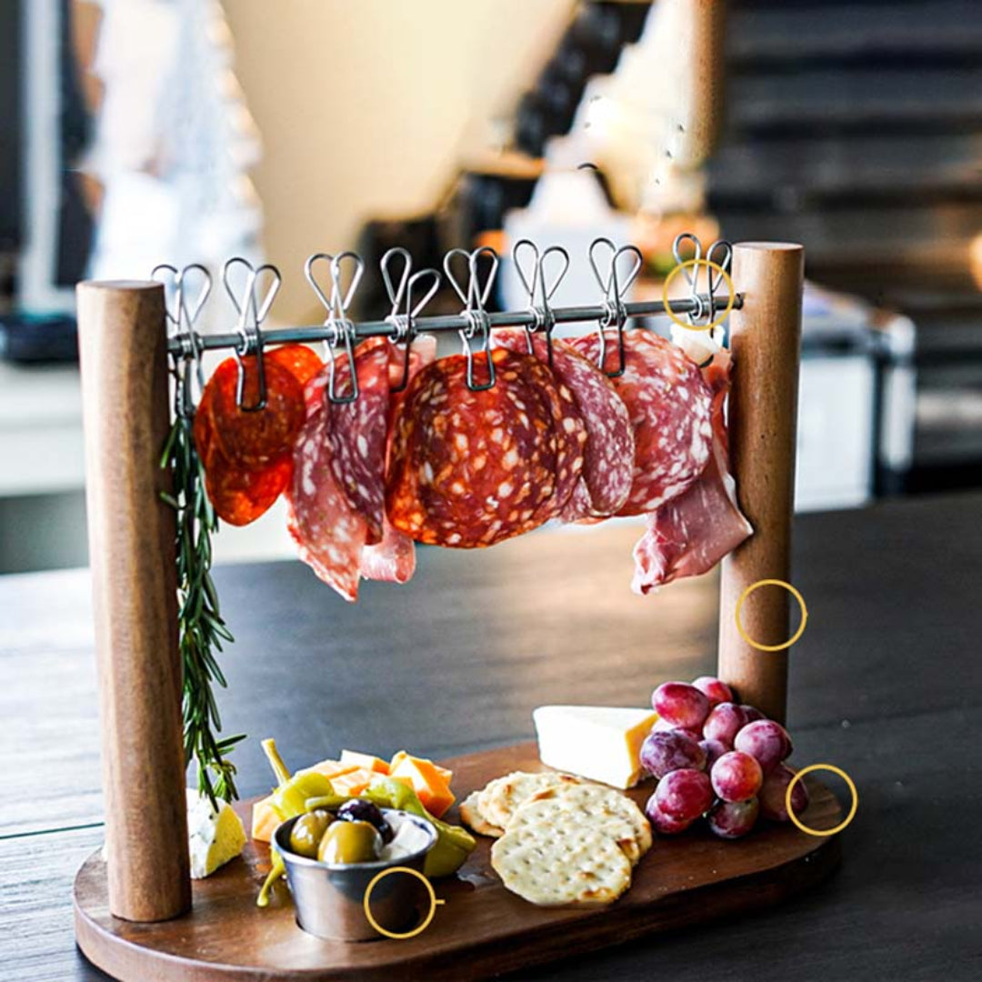 Wooden charcuterie board with cured meats, cheese, and fruits on a blurred background