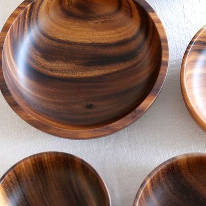 Set of wooden bowls with a focus on texture and grain.
